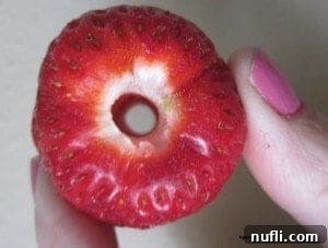 Clean Strawberry A perfectly hulled strawberry with a clean hole through the middle, ready for use.