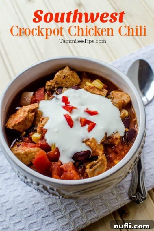 Zesty Slow Cooker Southwest Chicken Chili 2 Southwest Crockpot Chicken Chili over a bowl of chili topped with sour cream, next to a silver spoon on a white napkin
