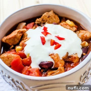 Zesty Slow Cooker Southwest Chicken Chili 4 Southwest Crockpot Chicken Chili with sour cream garnish in a cream colored bowl