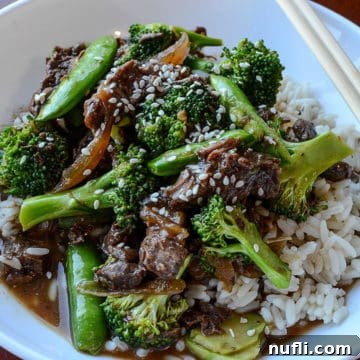 Slow Cooker Beef and Broccoli 7 crockpot beef and broccoli in a white bowl with chopsticks
