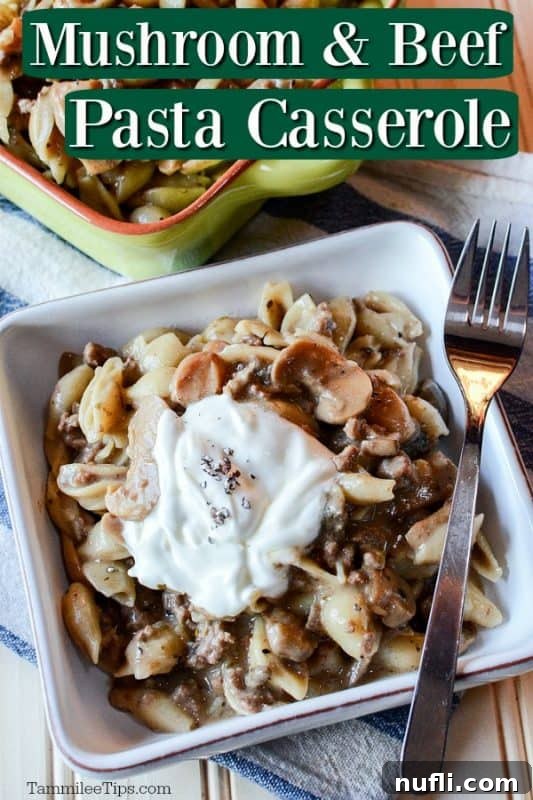 A delectable Slow Cooker Mushroom Pasta Casserole, served in a pristine white dish with a fork resting beside it, invitingly showcasing the rich blend of mushrooms, beef, and pasta.