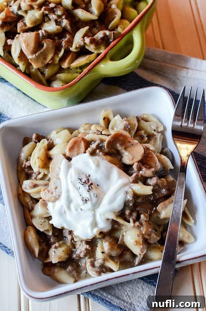 A close-up shot of the bubbling Crock Pot Mushroom, Ground Beef, Pasta Casserole, highlighting its creamy texture and rich ingredients simmering to perfection before the final serving.