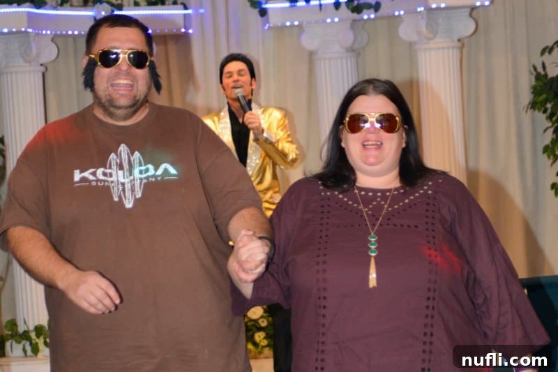 Vegas Vows Renewed Elvis Style 4 Tammilee and John walking down the aisle with elvis impersonator performing behind them.