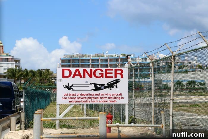 Danger person being blown away from a plane sign 