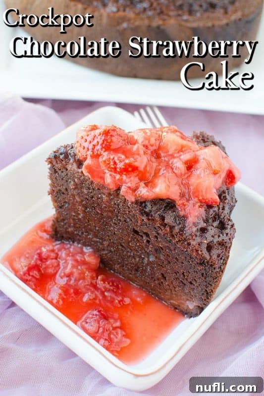 A slice of moist slow cooker chocolate strawberry cake on a white plate, topped with fresh strawberries and chocolate sauce.