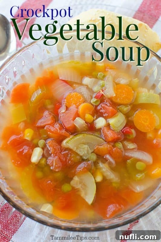 Crockpot vegetable soup over a clear bowl filled with soup, garnished with fresh herbs