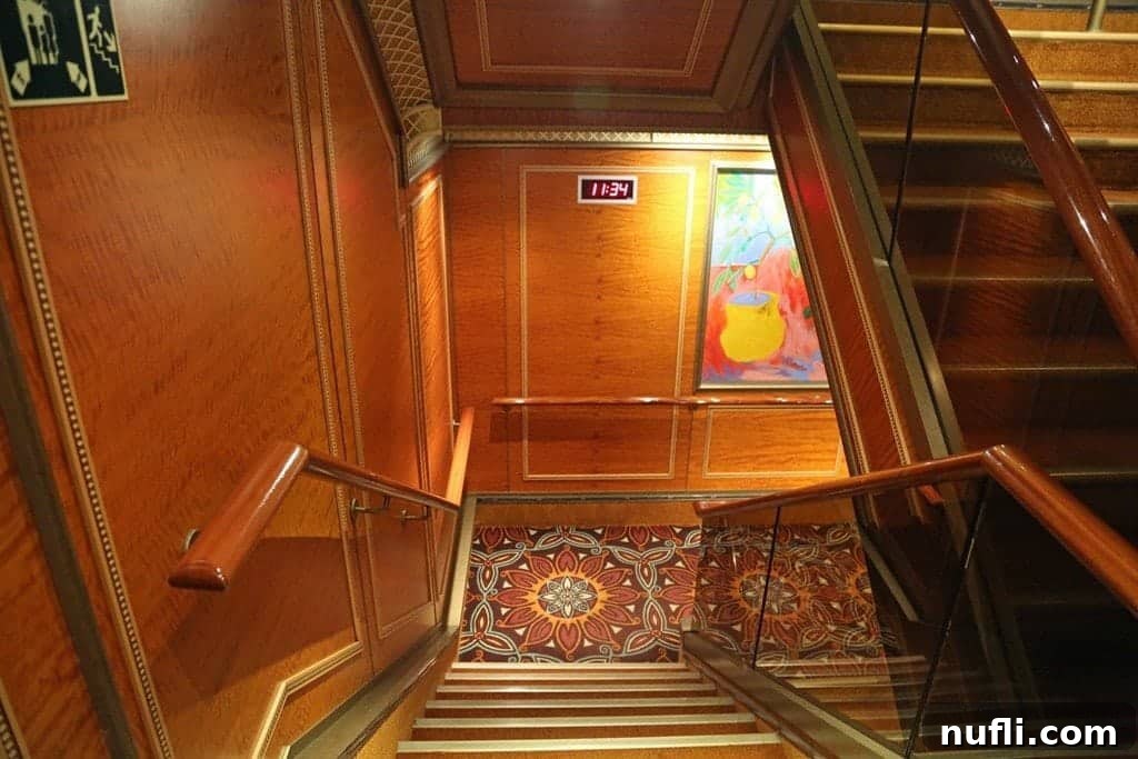 Stairs down a ship with a digital clock on the wall