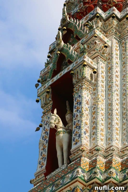 Statue of Nayu, the Hindu god of wind, riding a horse, located in a niche of a minor prang at Wat Arun