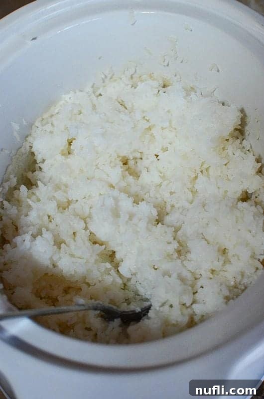 Rice in a slow cooker bowl with a fork