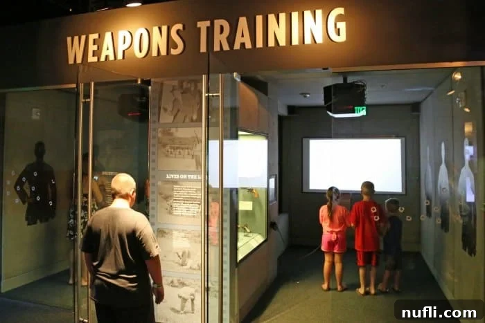 Museum visitors engaging with an interactive exhibit on historical weapons and law enforcement tactics, showcasing the museum's immersive experience