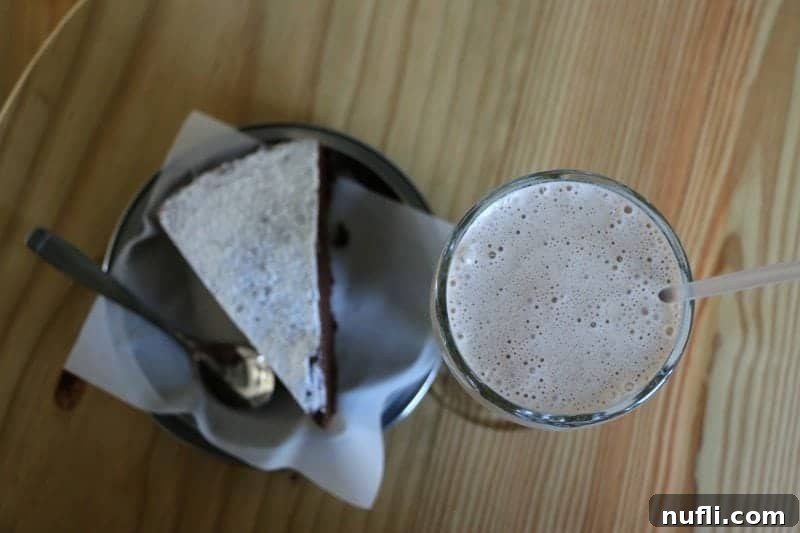 Slice of cake and frozen coffee on a table
