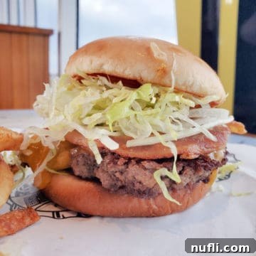 Guy’s Burger Joint Burger Straight-Up with a Pig Patty Burger on a plate