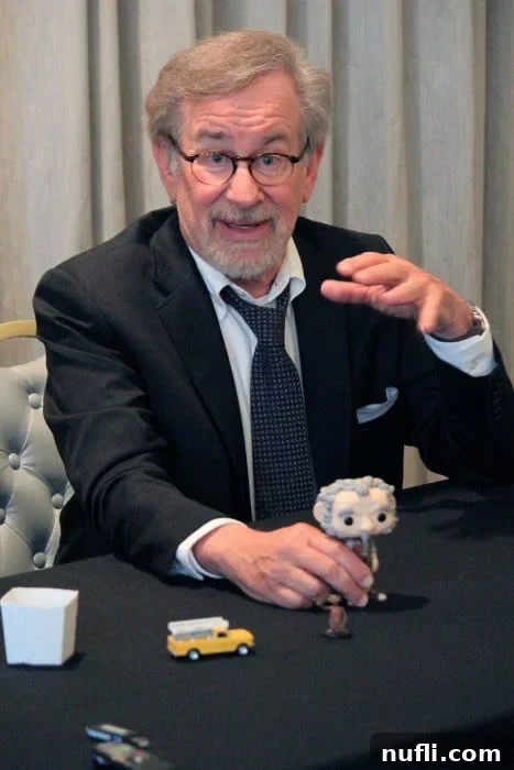 Steven Spielberg at a table with a bobblehead