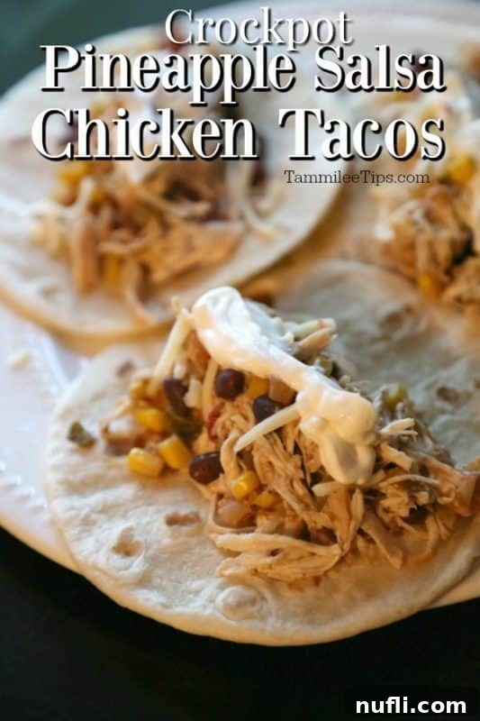 Crockpot Pineapple salsa chicken tacos served on warm tortillas with fresh cilantro and a lime wedge