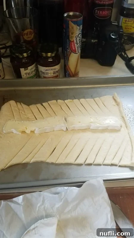 crescent roll with brie down the middle of it 