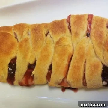 Strawberry Brie Braided Crescent on a white platter