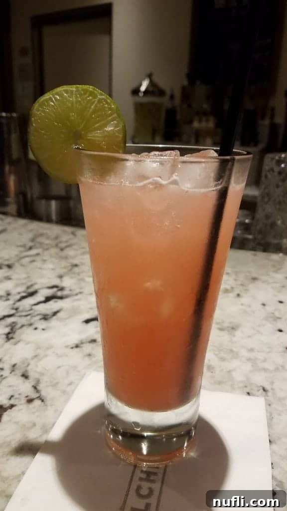 Carnival's Alchemy Bar: The Ultimate Cruise Hotspot 14 Close-up of a bartender performing a flaming garnish technique for a cocktail