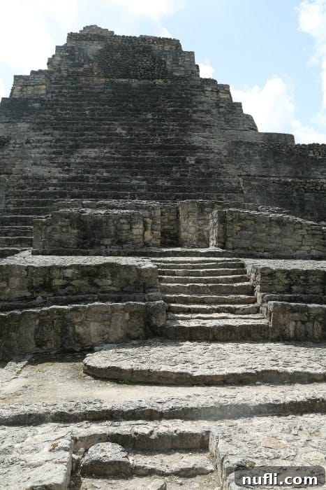 Chacchoben: Ancient Mayan Jungle Exploration from Costa Maya 8 Close-up of weathered stone steps and intricately carved stones on a Mayan pyramid at Chacchoben Ruins.