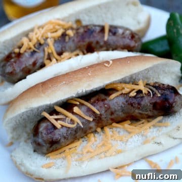 Bold Jalapeno Beer Brats 6 Two jalapeno beer brats on buns with shredded cheese