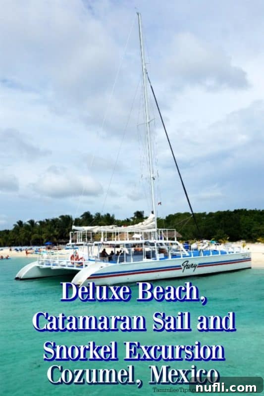 A person posing next to a luxury catamaran in the clear blue waters of Cozumel, ready for snorkeling.