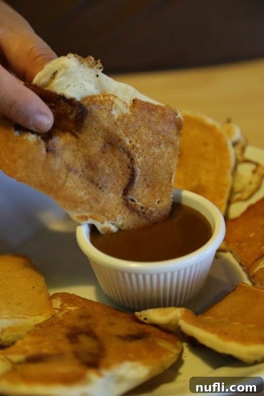 Golden pancakes with crispy bacon, ready to be dipped in sweet syrup