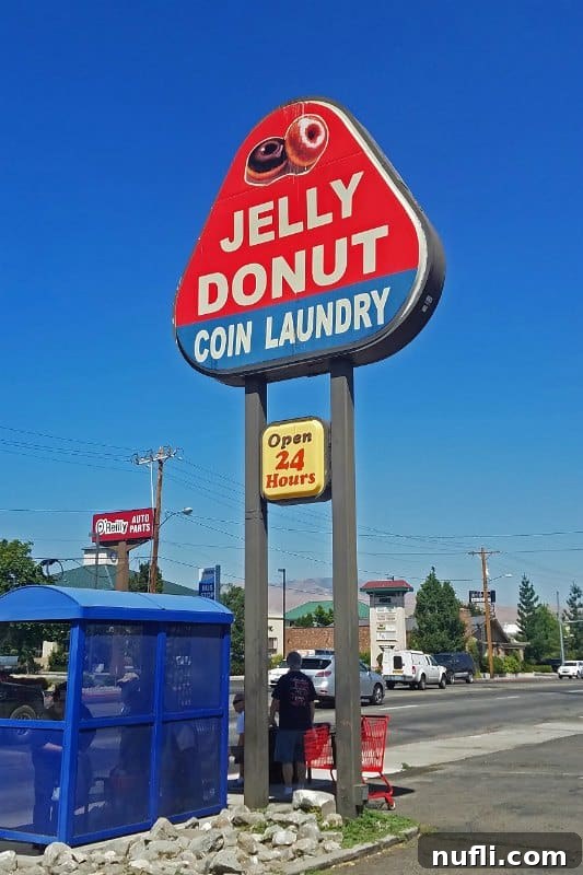 Jelly Donut Coin Laundry sign next to a bus stop 