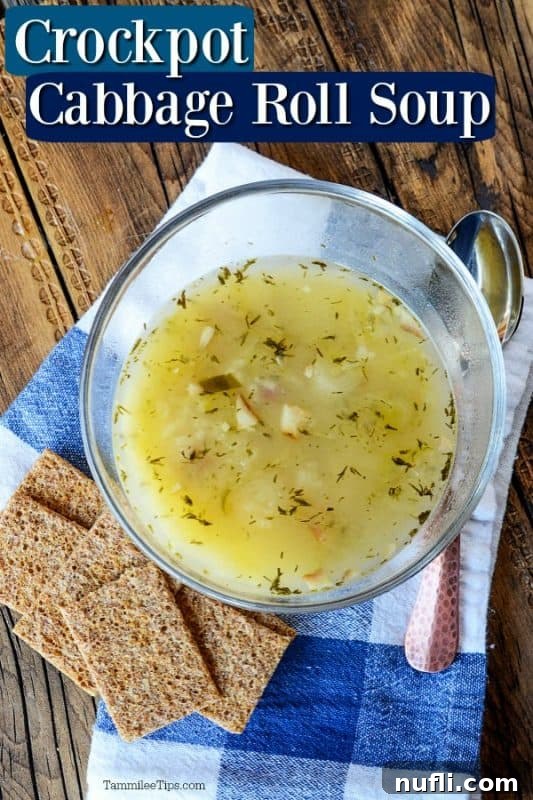 Crockpot cabbage roll soup over a clear bowl filled with soup, crackers and a spoon