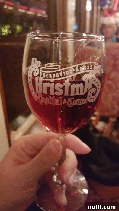 Grapevine Christmas Capital Texas wine glass against a festive backdrop