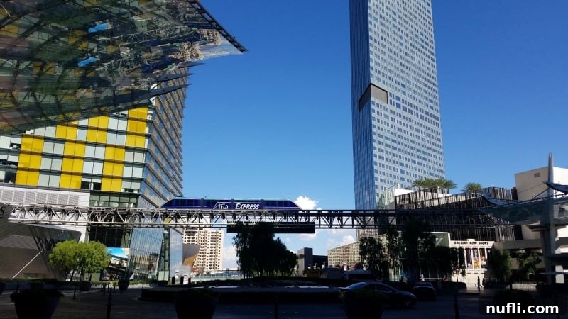 The Aria Express Tram, a convenient monorail, passing by the modern architecture of the Aria hotel in Las Vegas.
