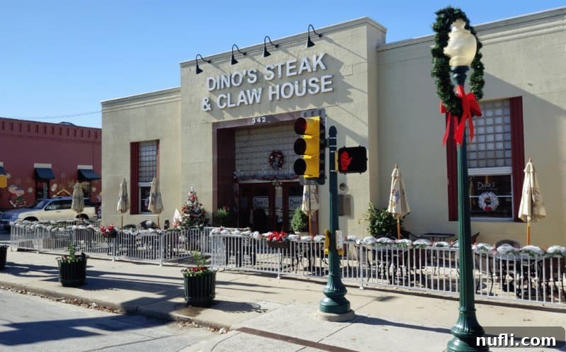 Dino's Steak & Claw House exterior adorned with festive holiday decorations