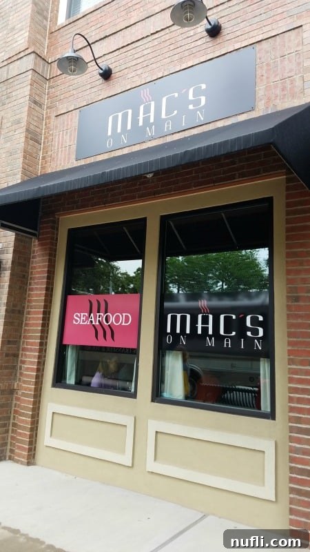 Macs on Main restaurant sign elegantly displayed on a glass window