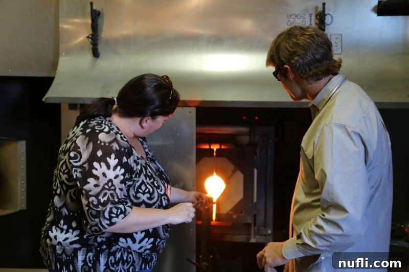 Tammilee holding a rode in a glass blowing vent