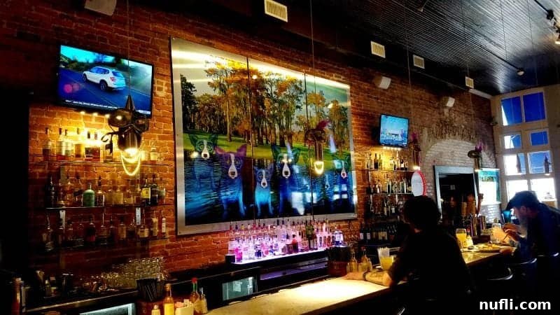 Elegant restaurant interior adorned with a vibrant Blue Dog painting by George Rodrigue, creating a unique ambiance.