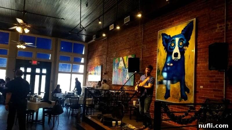 Blue dog painting on the wall with a singer below it