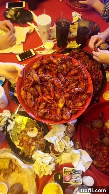 Large circular platters overflowing with freshly boiled crawfish, a classic Louisiana seafood spread.