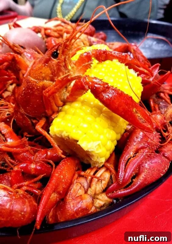 Crawfish over a piece of corn on a platter