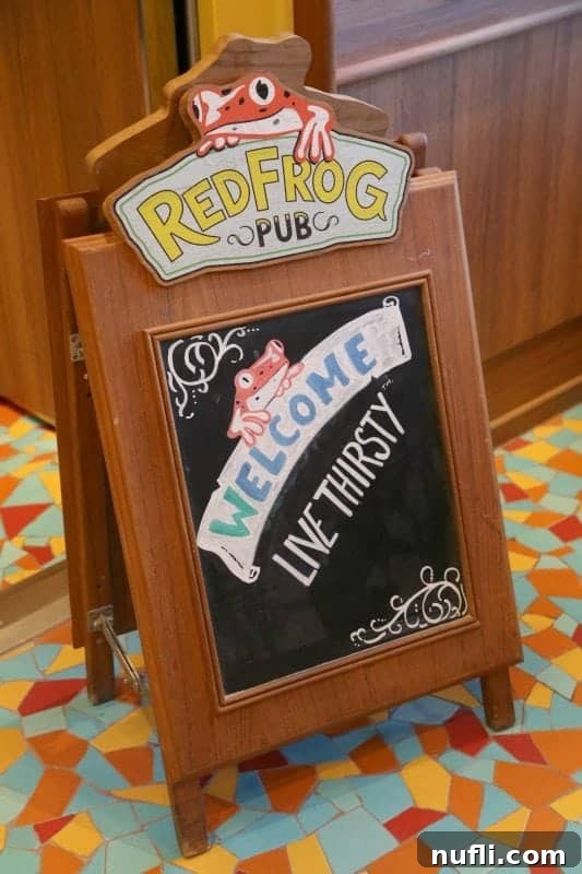 Red Frog Pub sign with the inviting motto 'Welcome, Live Thirsty'.