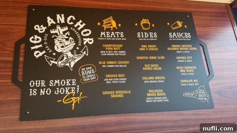 The tempting menu for Guy Fieri's Pig & Anchor, detailing a variety of smoked meats, savory sides, and signature sauces.