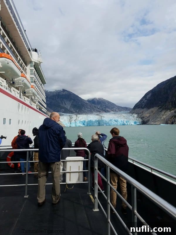 Looking down the side of a cruise ship to a glacier in the distance