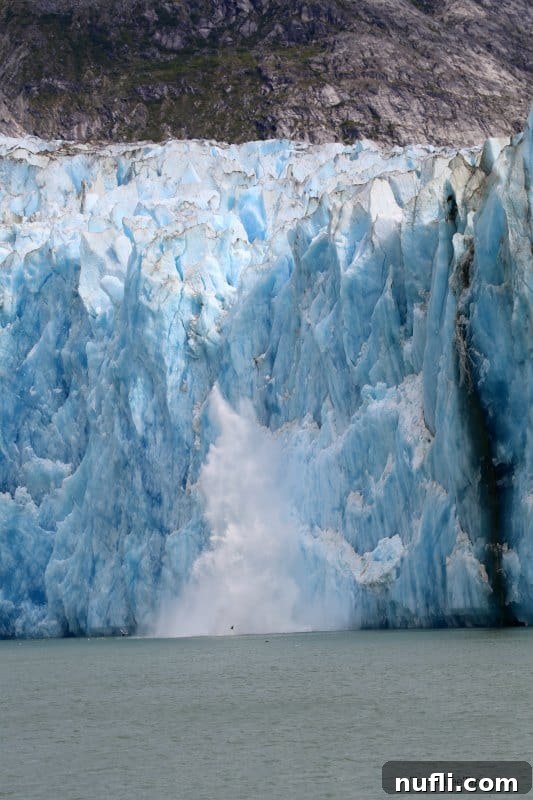 Glacier ice breaking off a glacier into the open water