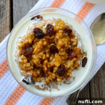 Overnight Crock Pot Pumpkin Oatmeal 5 Crock Pot Pumpkin Oatmeal with cream in a glass bowl on a cloth napkin, inviting and delicious.