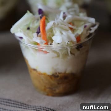 Layered Pulled Pork Perfection 5 Pulled pork parfait in a plastic cup on a cloth napkin