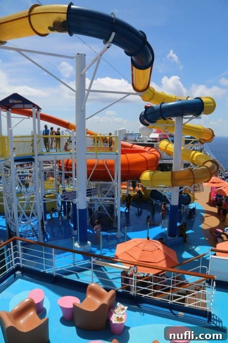 yellow and blue waterslide and pool deck on the Carnival Legend 