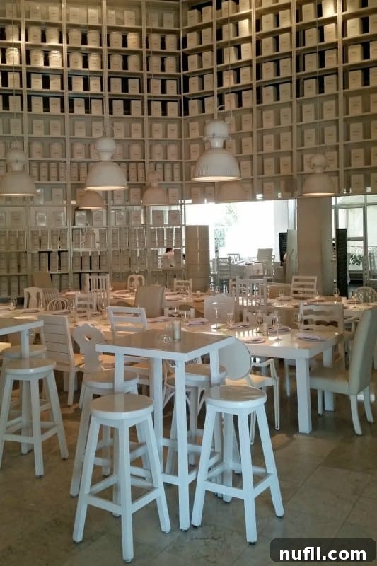 Completely white restaurant interior with tables, chairs, and all decorations white for a minimalist aesthetic