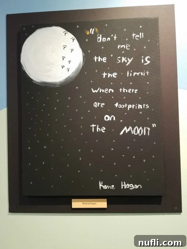 Inspirational quote: 'Don't tell me the sky is the limit when there are footprints on the moon' against a blue background.