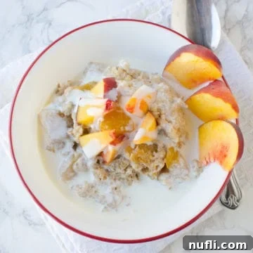 peaches and cream in a white bowl with sliced peaches
