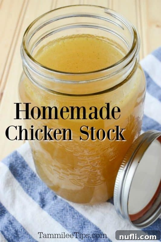 Homemade chicken stock in a mason jar glass on a cloth napkin, ready for use