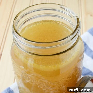 Homemade chicken stock in a mason jar glass