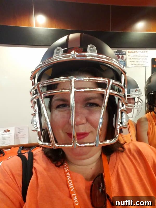 Tammilee wearing an OSU football helmet, smiling for the camera.