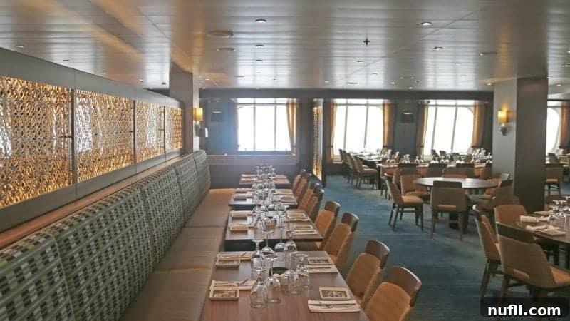 Dining area with tables along the wall and then tables closer to the window 